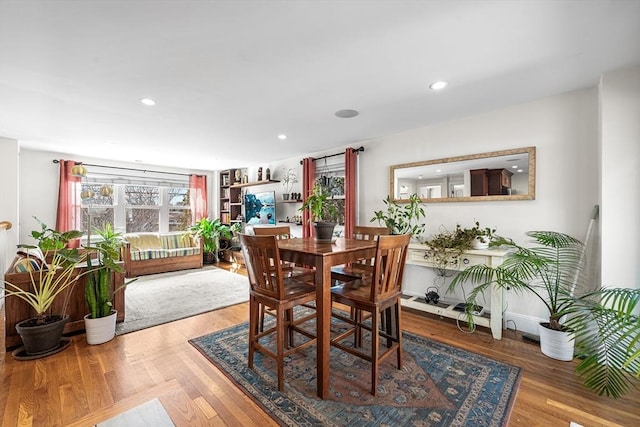 dining space featuring wood finished floors and recessed lighting