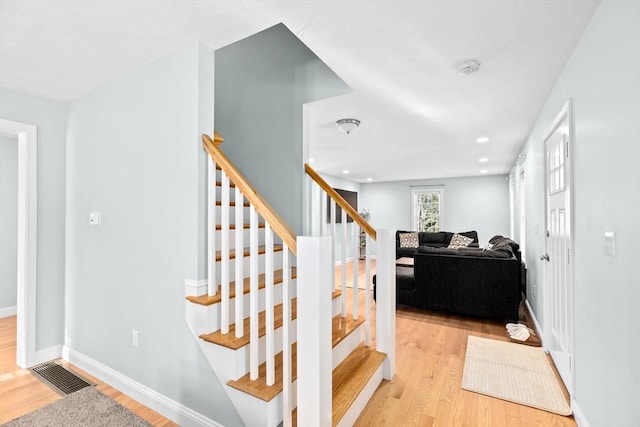 stairway with hardwood / wood-style floors