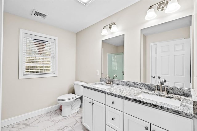 bathroom featuring vanity, toilet, and a shower with door