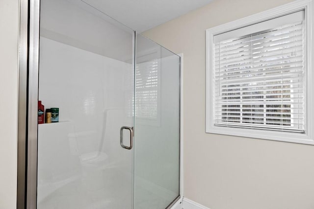 bathroom with a shower with door