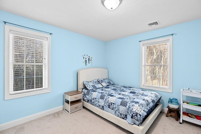 bedroom featuring light carpet