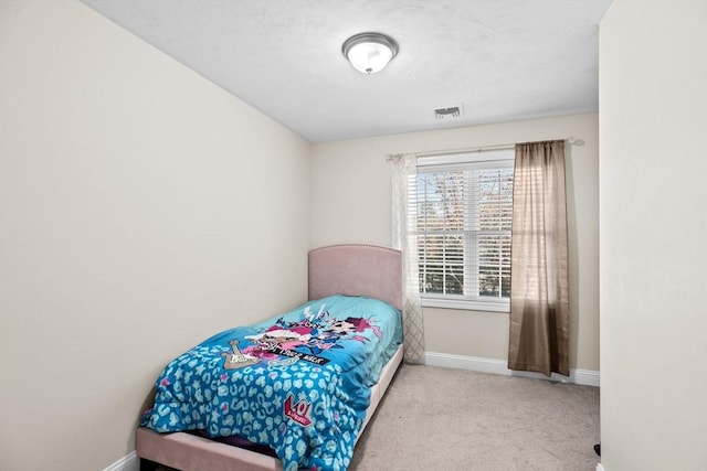 bedroom featuring light colored carpet