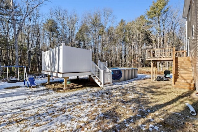 yard layered in snow featuring a wooden deck