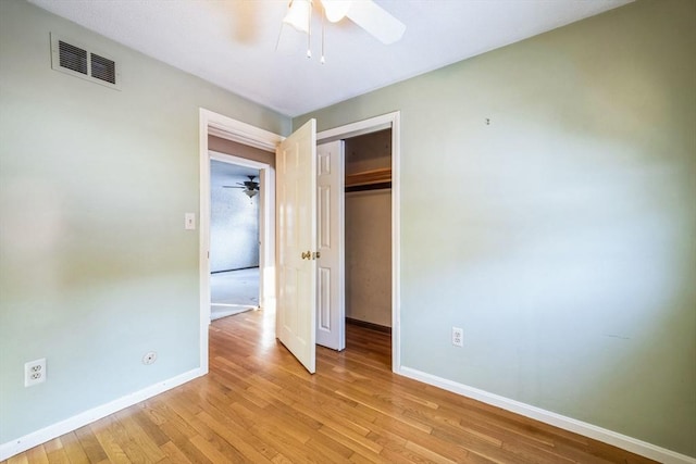 unfurnished bedroom with a closet, ceiling fan, and light hardwood / wood-style flooring