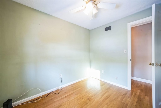 spare room with ceiling fan and light hardwood / wood-style flooring