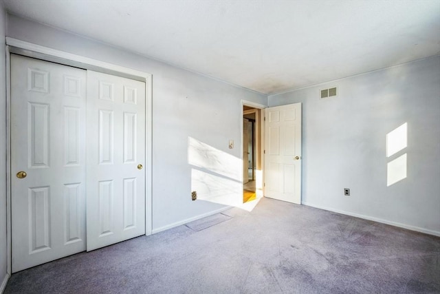 unfurnished bedroom with carpet floors and a closet