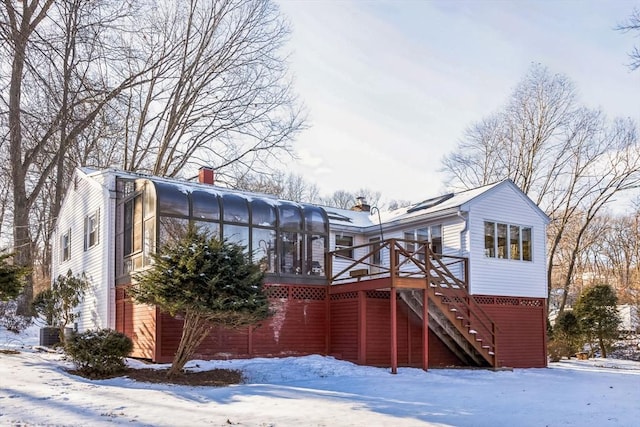 exterior space with a sunroom and a wooden deck