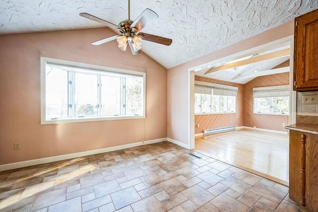 spare room with lofted ceiling, ceiling fan, a baseboard radiator, and a healthy amount of sunlight