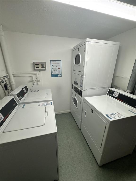 laundry room featuring separate washer and dryer and stacked washer / drying machine