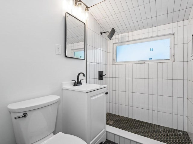 full bath with vanity, toilet, and tiled shower