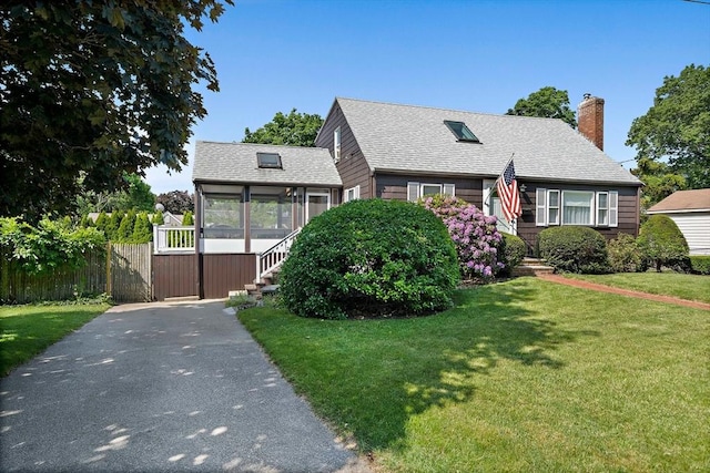 2 Winstead Rd, Weymouth, MA 02189 - view of front of property featuring a sunroom, a chimney, roof with shingles, and driveway