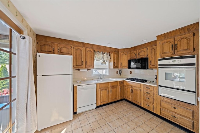 2 Winstead Rd, Weymouth, MA 02189 - kitchen with white appliances, a warming drawer, light tile patterned floors, a sink, and light countertops