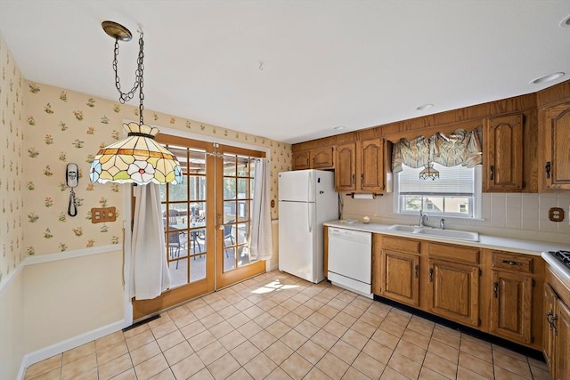 2 Winstead Rd, Weymouth, MA 02189 - kitchen with white appliances, a sink, french doors, brown cabinetry, and light countertops