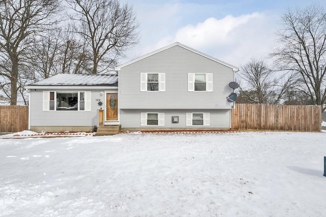 split level home featuring fence