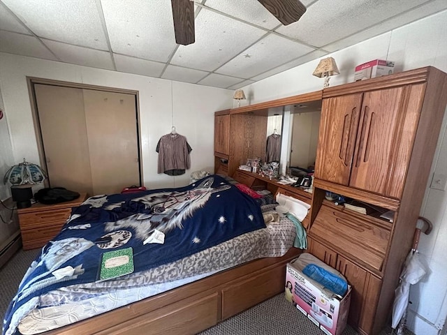 bedroom featuring a paneled ceiling, carpet floors, and ceiling fan