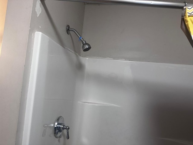 details featuring a tub to relax in and walk in shower