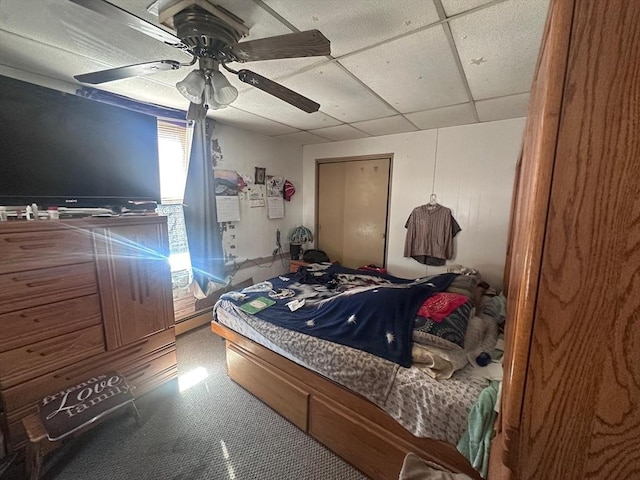 bedroom featuring a ceiling fan, a paneled ceiling, and baseboard heating