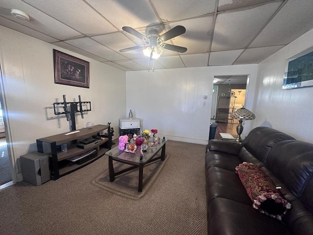 carpeted living room featuring a paneled ceiling, baseboards, and ceiling fan