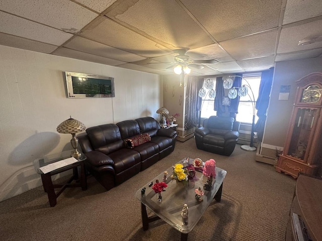 living room with carpet, a drop ceiling, and ceiling fan