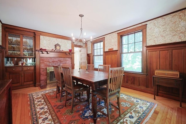 95 Glendale Rd, Sharon, MA 02067 - dining area with a chandelier, wallpapered walls, wainscoting, light wood finished floors, and ornamental molding