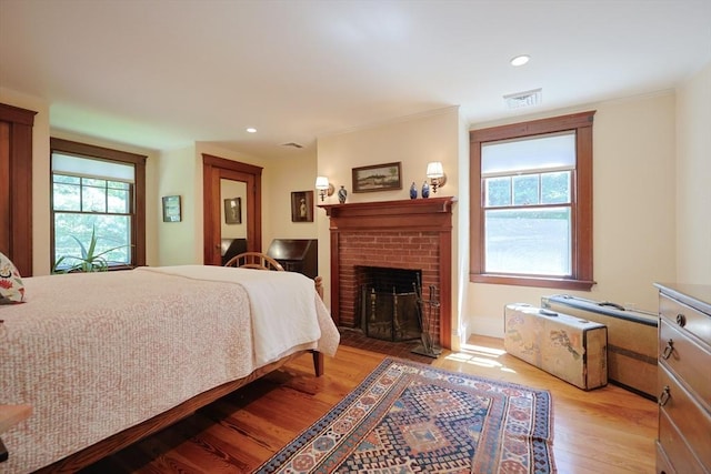 95 Glendale Rd, Sharon, MA 02067 - bedroom with light wood-style flooring, a brick fireplace, and recessed lighting