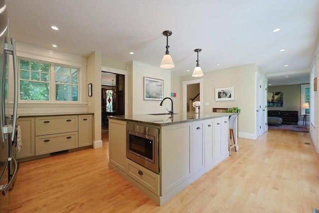 95 Glendale Rd, Sharon, MA 02067 - kitchen with stainless steel appliances, light wood-style floors, an island with sink, recessed lighting, and pendant lighting