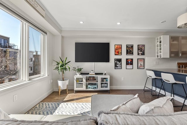 living area featuring recessed lighting, baseboards, and wood finished floors