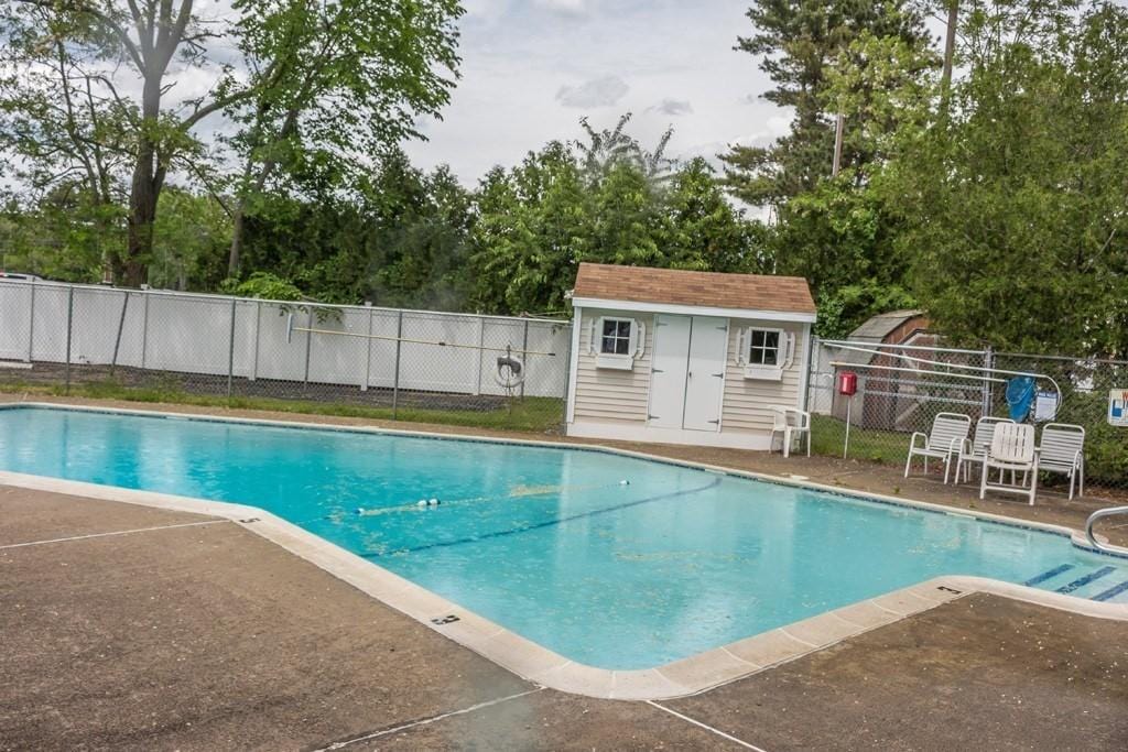 view of swimming pool featuring fence, a patio area, and a fenced in pool