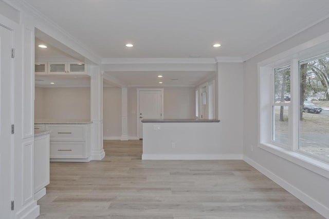 interior space with crown molding, light wood finished floors, recessed lighting, and baseboards