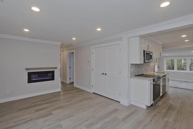 kitchen featuring white cabinetry, light wood-style floors, electric stove, tasteful backsplash, and stainless steel microwave