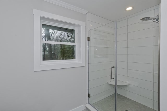 bathroom with baseboards, ornamental molding, a stall shower, and recessed lighting