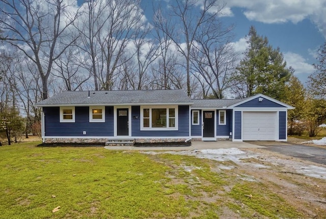 ranch-style house featuring driveway, a front lawn, and an attached garage