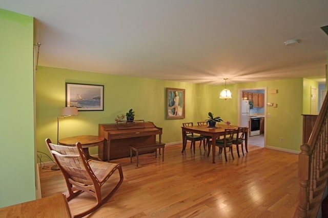575 Bridge Rd Unit 11-2, Northampton, MA 01060 - dining area with light wood finished floors, baseboards, and stairway