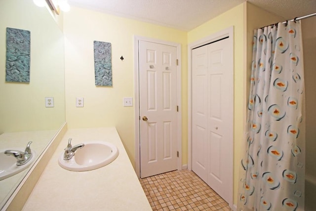 575 Bridge Rd Unit 11-2, Northampton, MA 01060 - full bath featuring a closet, vanity, and a textured ceiling