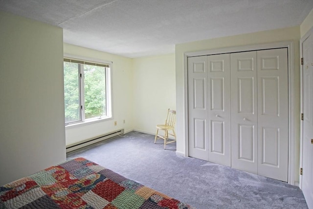 575 Bridge Rd Unit 11-2, Northampton, MA 01060 - unfurnished bedroom with a baseboard heating unit, carpet flooring, a textured ceiling, and a closet