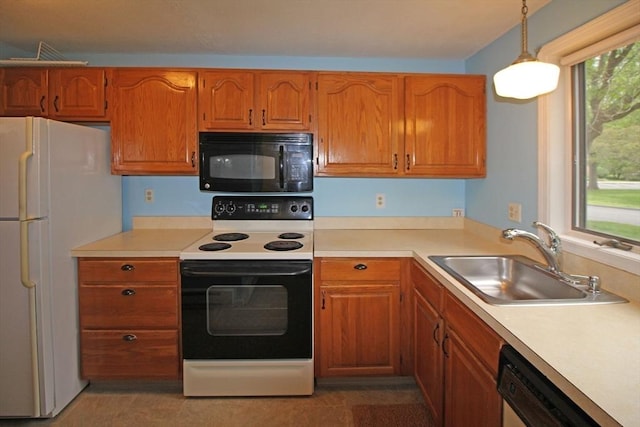 575 Bridge Rd Unit 11-2, Northampton, MA 01060 - kitchen featuring black microwave, electric range oven, freestanding refrigerator, a sink, and light countertops