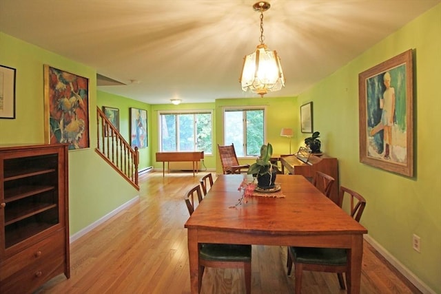 575 Bridge Rd Unit 11-2, Northampton, MA 01060 - dining room with stairway, wood finished floors, a chandelier, baseboards, and a baseboard radiator