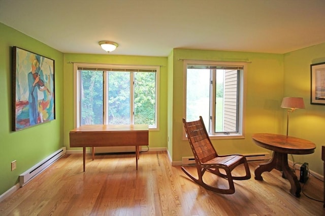 575 Bridge Rd Unit 11-2, Northampton, MA 01060 - sitting room featuring baseboard heating, light wood-style floors, baseboards, a desk, and a baseboard radiator