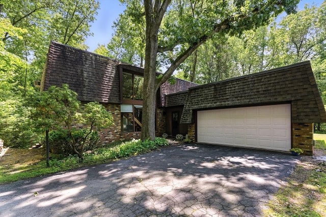 26 Ashfield Ln, South Hadley, MA 01075 - view of front of property featuring brick siding, asphalt driveway, and an attached garage