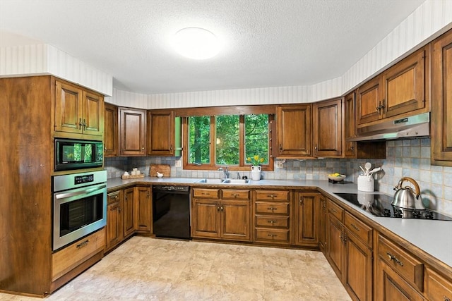 26 Ashfield Ln, South Hadley, MA 01075 - kitchen featuring black appliances, under cabinet range hood, decorative backsplash, brown cabinets, and a textured ceiling
