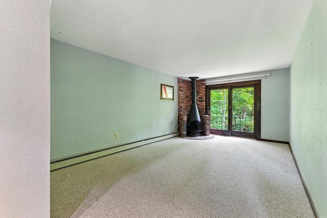 26 Ashfield Ln, South Hadley, MA 01075 - unfurnished living room featuring a baseboard radiator and a wood stove
