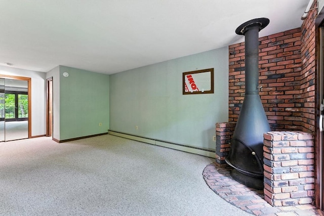 26 Ashfield Ln, South Hadley, MA 01075 - unfurnished living room with a baseboard radiator, a wood stove, and carpet flooring