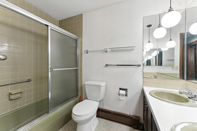 26 Ashfield Ln, South Hadley, MA 01075 - full bath with a baseboard radiator, double vanity, and shower / bath combination with glass door