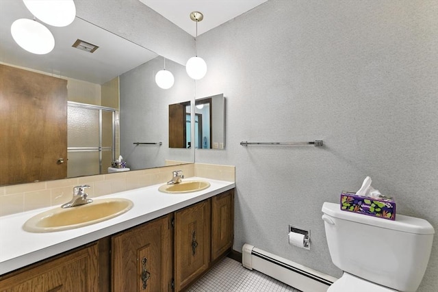 26 Ashfield Ln, South Hadley, MA 01075 - bathroom featuring a baseboard heating unit, double vanity, a shower with shower door, and tile patterned floors