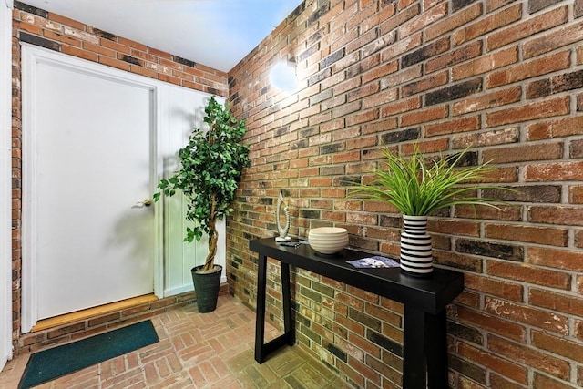 26 Ashfield Ln, South Hadley, MA 01075 - foyer featuring brick floors and brick wall