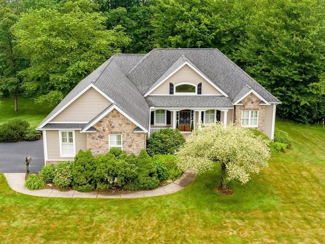 9 Windsor Ln, East Longmeadow, MA 01028 - view of front of property with stone siding, roof with shingles, and a front yard