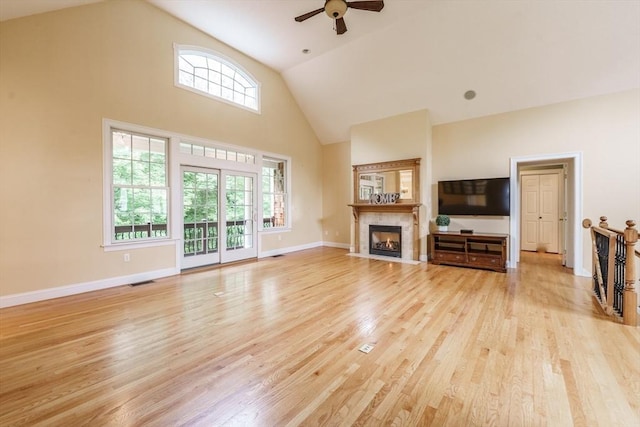 9 Windsor Ln, East Longmeadow, MA 01028 - unfurnished living room with high vaulted ceiling, light wood-type flooring, ceiling fan, and a fireplace with flush hearth