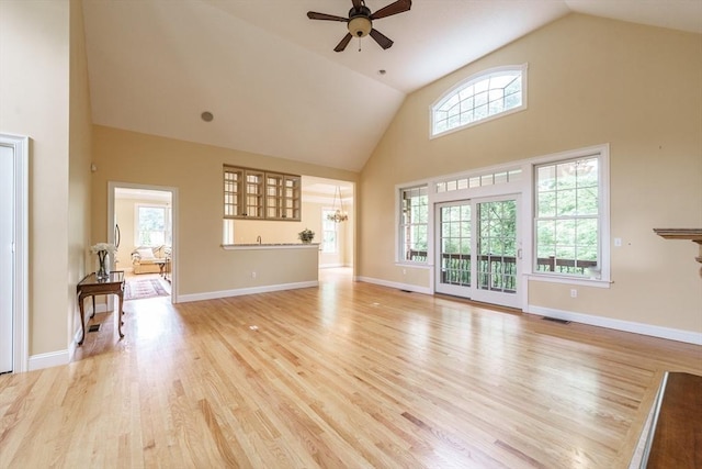 9 Windsor Ln, East Longmeadow, MA 01028 - unfurnished living room with high vaulted ceiling, a ceiling fan, light wood-type flooring, and a chandelier