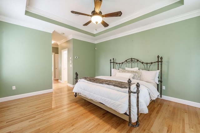 9 Windsor Ln, East Longmeadow, MA 01028 - bedroom featuring a tray ceiling, light wood-style flooring, ornamental molding, and a ceiling fan