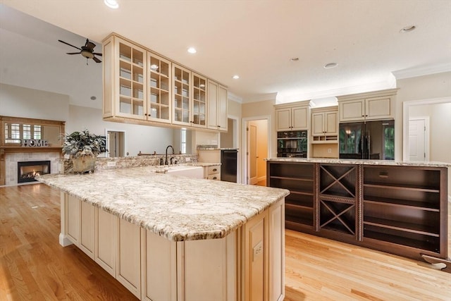 9 Windsor Ln, East Longmeadow, MA 01028 - kitchen with cream cabinetry, black appliances, ornamental molding, light wood finished floors, and a ceiling fan